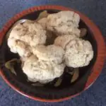 Baked cookies stacked on top of a plate.