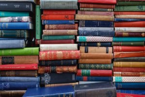 Four stacks of antique books.