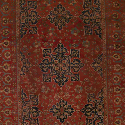 Close up shot of a red patterned rug.
