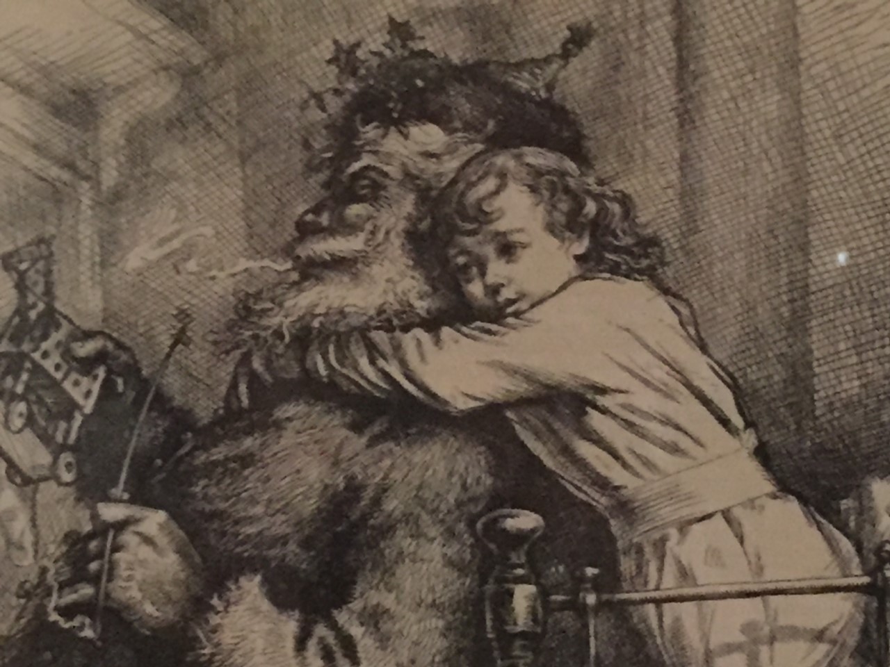 Drawing of a small child hugging Santa Claus.